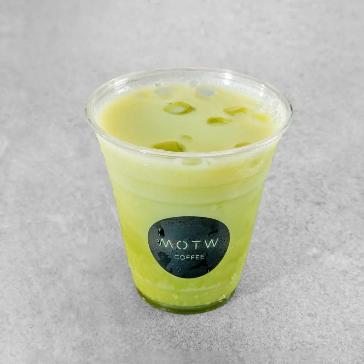Iced matcha latte in a MOTW Coffee cup